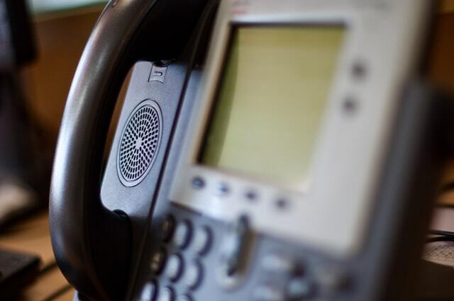 A desk phone. Image Source: Photo by Dan Dennis on Unsplash