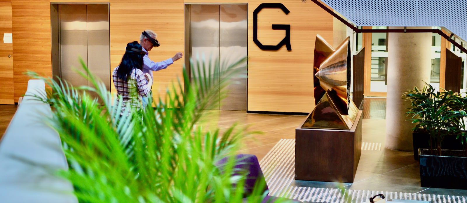 Two users evaluating an interface in an office foyer.